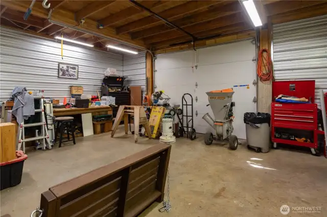Shop has a power-lift insulated garage door installed. Shop has insulation and paneling downstairs & upstairs.
