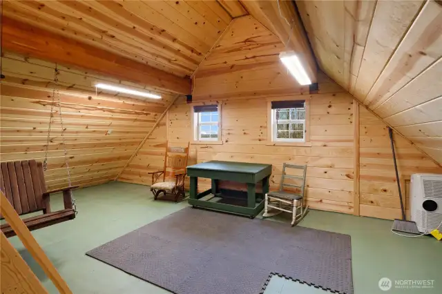 The insulated, upper garage level is quite livable. Nice paneling, windows, water source on upper level with a 3/4 bath and washer/dryer on the main level.
