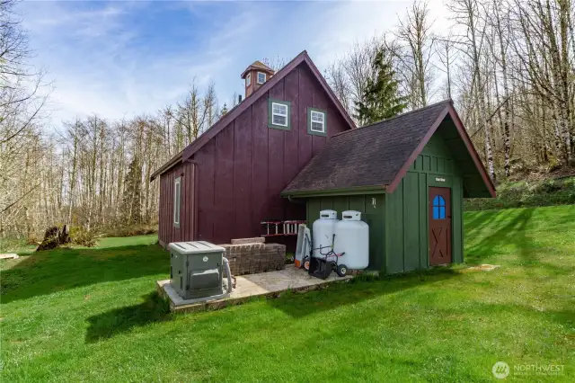 16K whole-house generator is propane driven & automatically turns on during a power outage. The shop has 2 bays,  a 3/4 bath, W/D, and livable loft space. Space for an RV to park with a dump site.