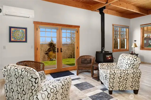 The great room has a wonderful wood-burning stove and a mini-ductless that heats & cools the room.