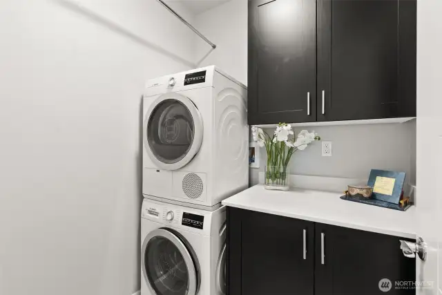 Dedicated laundry room with extra storage- perfect for linens.