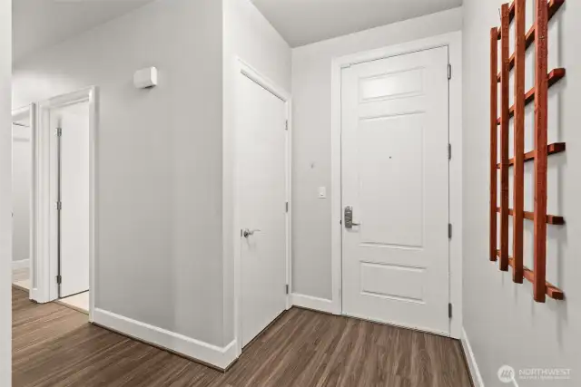 Entering through the interior entrance you will find a conveniently located coat closet, perfect for keeping things tidy upon arrival. Laundry room and half bath are pictured to the left of the photo.