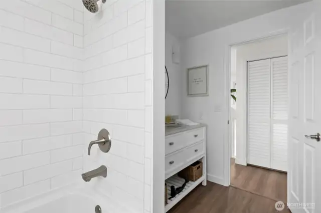 This modern and sleek bathroom is the main guest bath. It's got a fresh vibe with its clean lines and contemporary finishes.