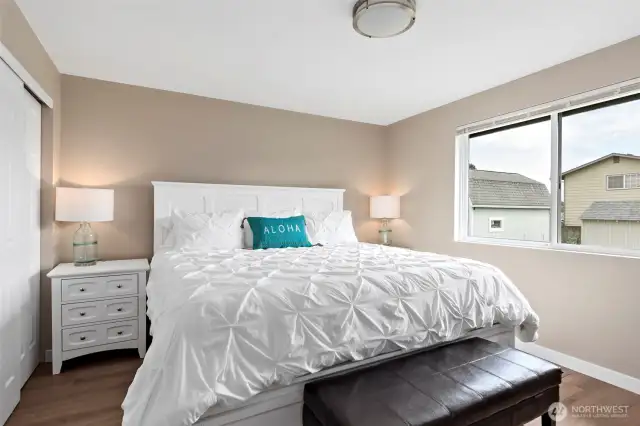 The spacious primary bedroom features a generous closet and a private ensuite bath, complete with a new shower, modern vanity, updated flooring, and stylish lighting—your own personal retreat.