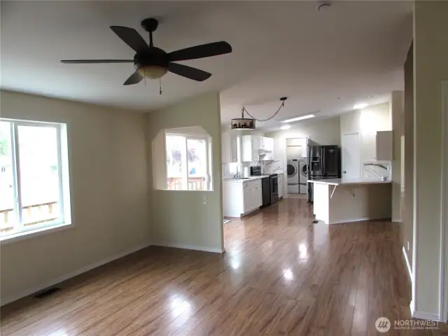 NORTH SIDE OF HOME HAS LARGE WINDOW W/ GOOD NATURAL LIGHTING. KITCHEN W/ UTILITY ROOM IS BACK LEFT AREA.