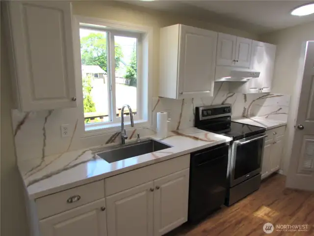NEW COUNTER TOPS W/ BACKSPLASH ACCENT, UPDATED APPLIANCES/ SINK AND 3 SKYLIGHTS.