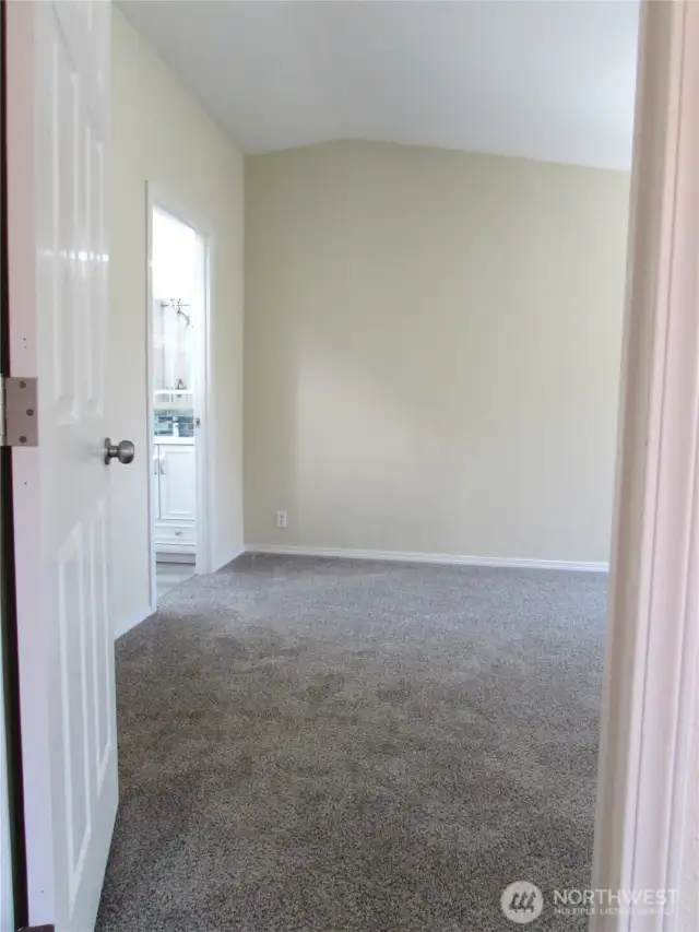 PRIMARY BEDROOM ENTRY W/ PRIVATE BATH ENTRY & WALK-IN CLOSET TO LEFT.