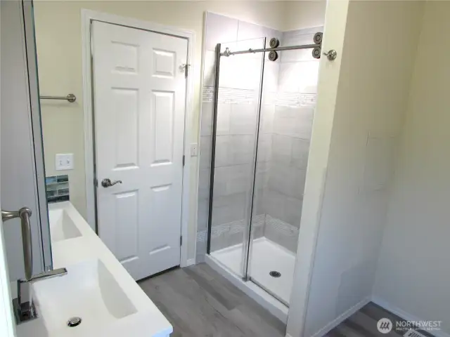 CERAMIC TILE WALLS IN WALK-IN SHOWER WITHSKYLIGHT ABOVE.