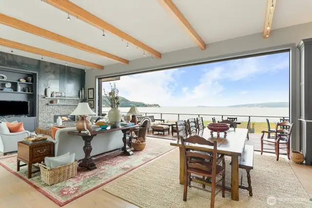 Great Room room with 12' beamed ceilings and wall of disappearing glass.