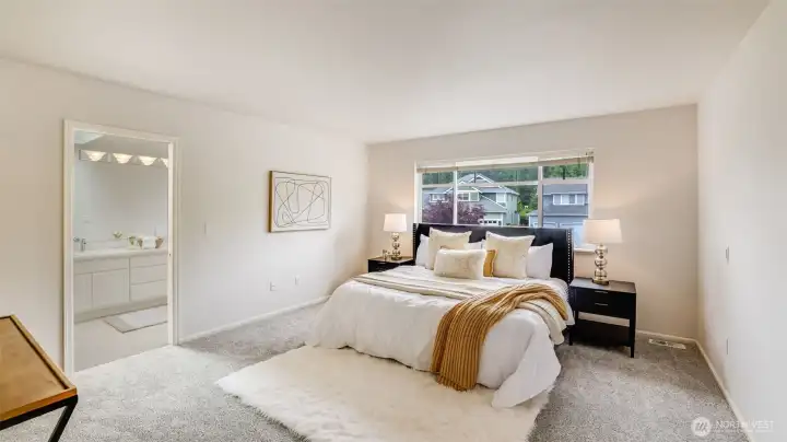 The primary bedroom features a spacious, open layout perfect for your personal design touch, with plenty of natural light streaming in. It also includes a connected en suite bathroom for added convenience