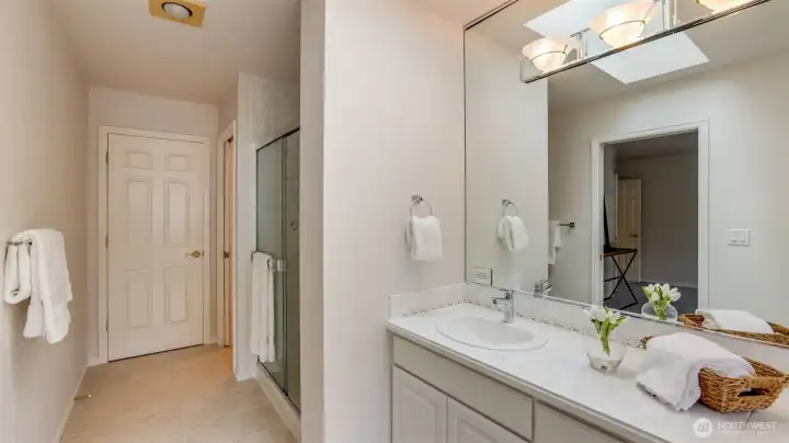 This sleek, modern bathroom features a spacious walk-in shower and a separate toilet area for added comfort and privacy