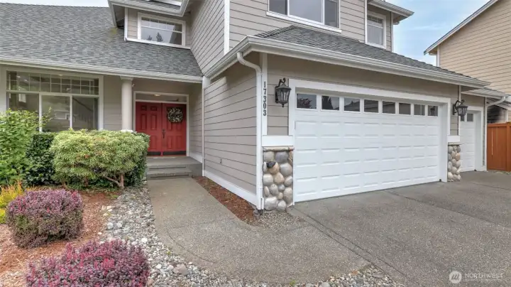 This home features a spacious 3-car garage, a wide driveway, and beautifully maintained landscaping for great curb appeal