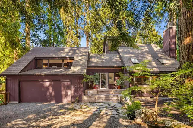 A stone pathway leads to the inviting front deck