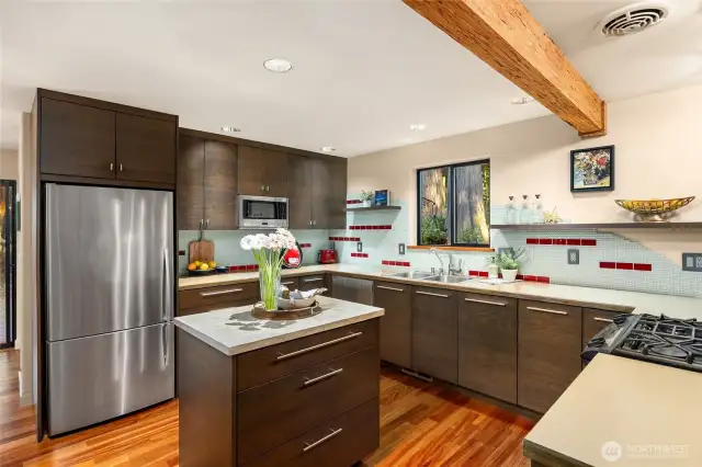 Features include stainless appliances, solid counters, limestone-topped center island, plenty of storage, and display/open shelving