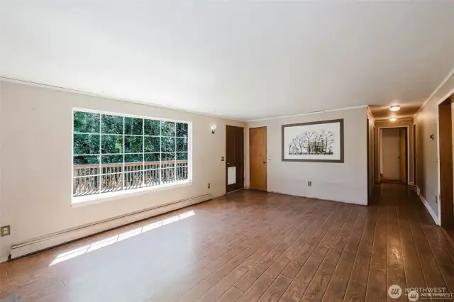 Shot of double paned window, coat closet and access to deck overlooking the stream.