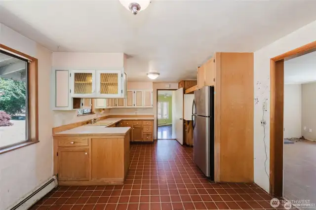 practical Galley like kitchen. Sink to left and fridge and place for range on the right.