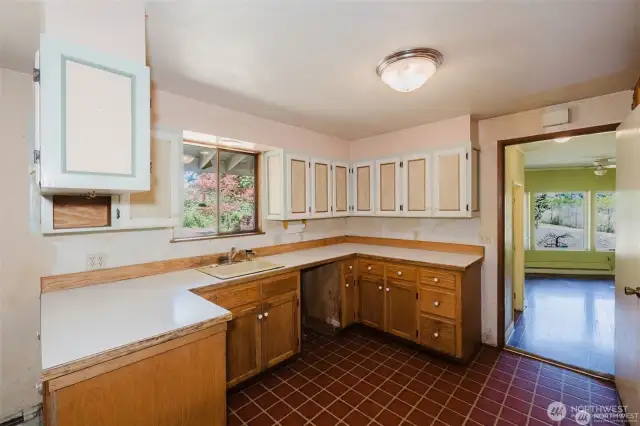 Kitchen window looks out to level grassy area. Keep an eye on things going on outside.