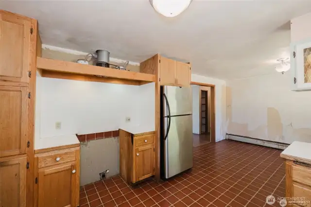 old range was removed. Outlet for electric range. Stainless steel fridge stays