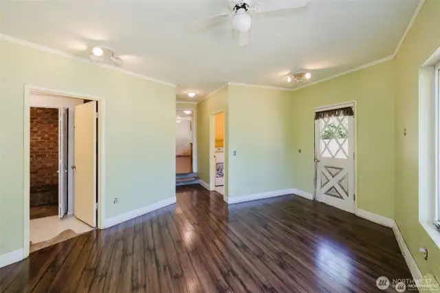 From left, entry to full bathroom and utility room behind. Large vanity, full tub and shower combo. short hall to Laundry room and step up to Kitchen.