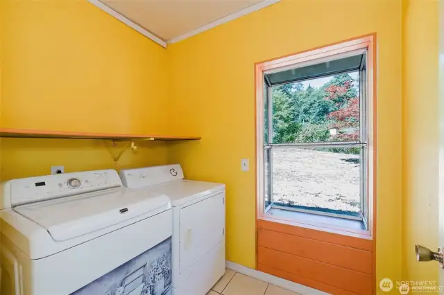 laundry room, washer and dryer stay. green house or art window over looks the lawn area