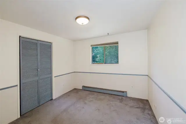 3rd bedroom, closet. This window also looks over the deck and stream.