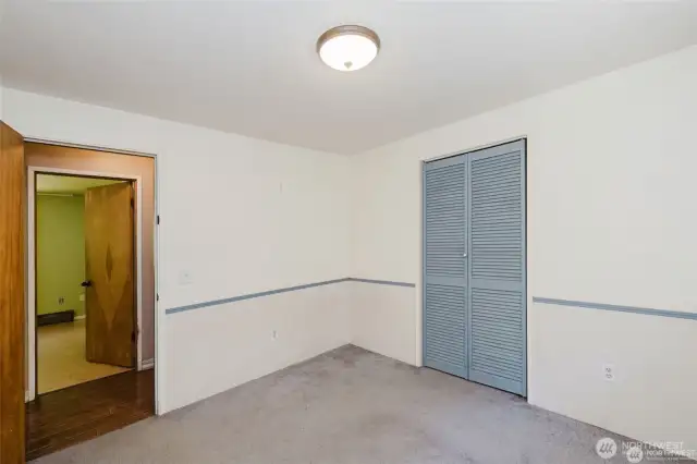 Another shot of 3rd bedroom looking into hallway and primary bedroom accross the hall.
