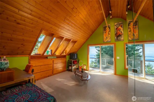 Master bedroom with built in storage, desk area and mirrored closets.