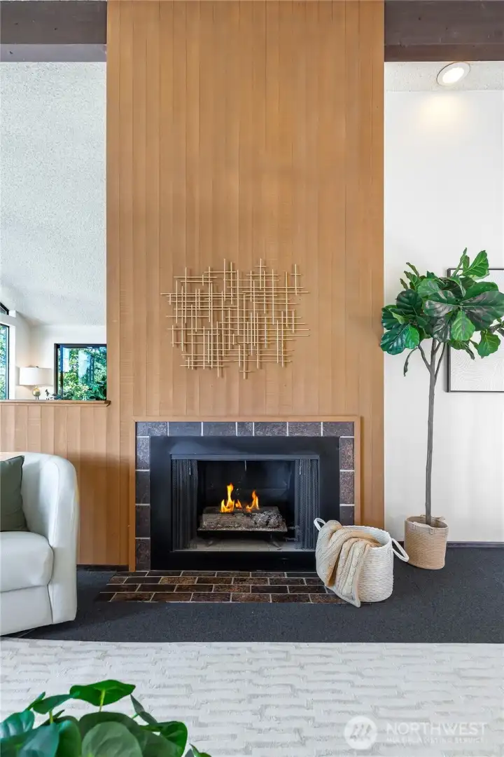 A soaring paneled hearth underscores the home’s mid-century integrity, its double-sided fireplace a striking centerpiece of architectural drama.”