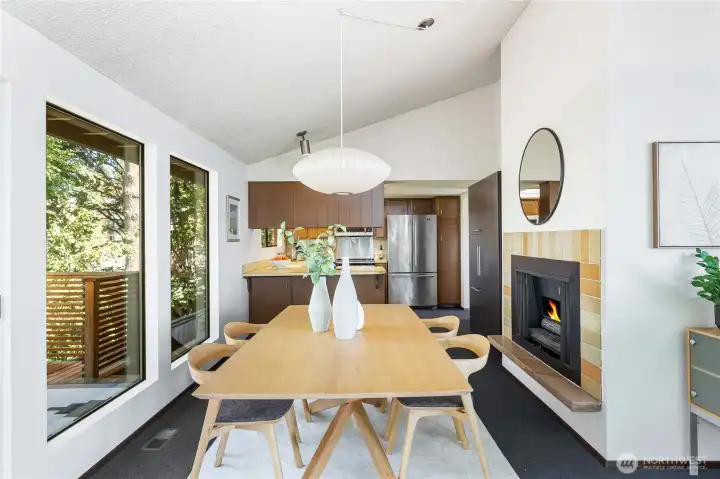 Kitchen opens seamlessly to dining and outdoor living areas, where surrounding trees provide a private green canopy for meals and gatherings.”