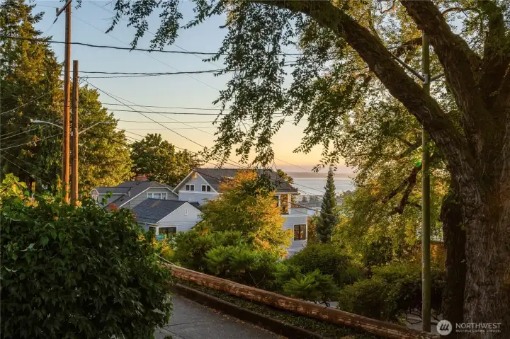 Puget Sound views from the west slope, with everyday favorites close at hand—Macrina Bakery, Ken’s Market, Good Society Brewery, Trader Joe’s, Metropolitan Market, and Whole Foods all nearby.