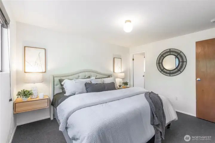Primary bedroom on the main floor (10’-6” x 12’-8”), one of three bedrooms in a quiet wing, complete with en suite bath.”