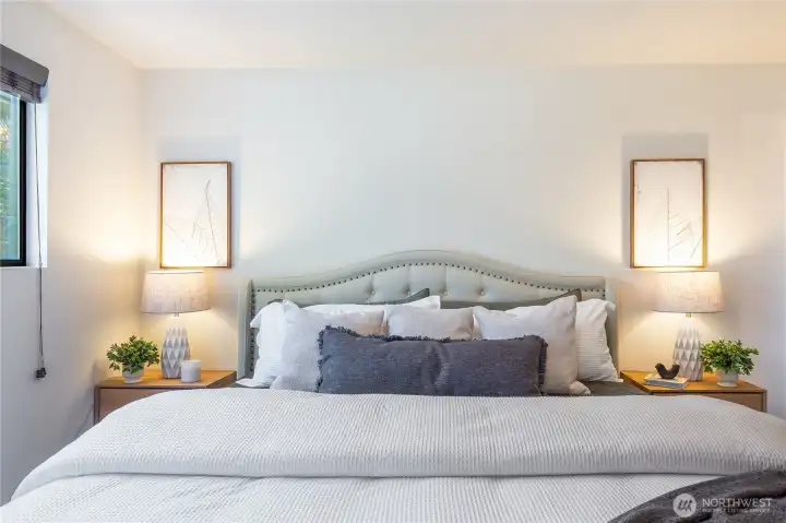 Primary bedroom on the main floor (10’-6” x 12’-8”), set at the back of the lot for added quiet and privacy.”