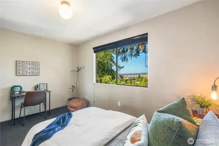Second bedroom – main floor (11’-0” x 13’-0”), with window framing Puget Sound outlooks.