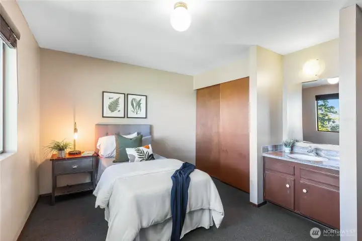 Third bedroom – main floor (11’-0” x 13’-3”), with built-in vanity and closet, ideal as a guest room or private study.