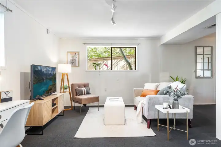 Garden Level living/dining area (12’-6” x 27’-0”) with full-size windows and garden outlooks, adaptable as media lounge, office hub, or potential ADU living room.