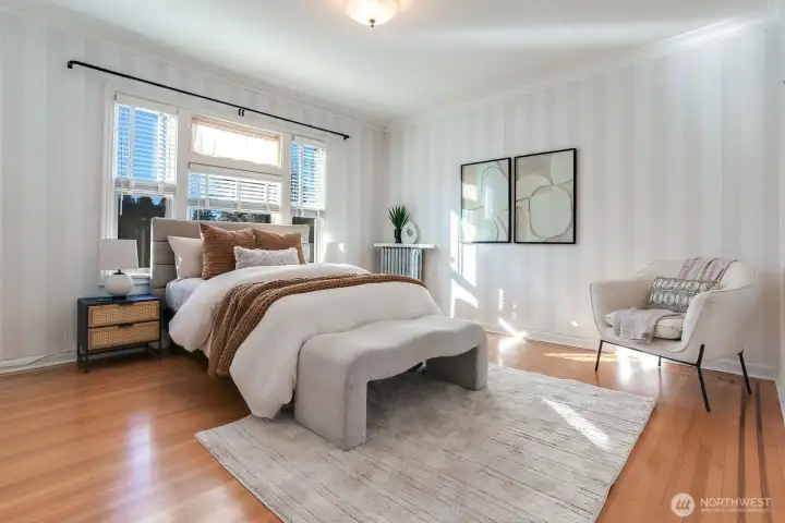 A large bedroom features plenty of light and closet space.