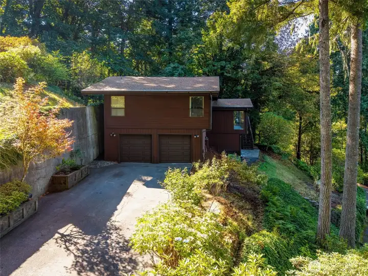 Pulling up to the house and the 2 car garage, front door entrance on the left