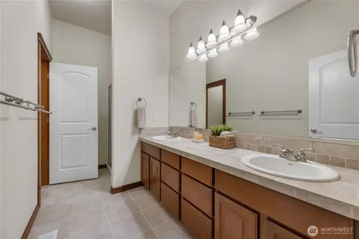 Mother in law bathroom with dual sinks, shower and separate toilet area