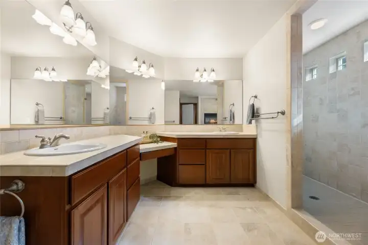 Primary suite bathroom with walk in large tiled shower