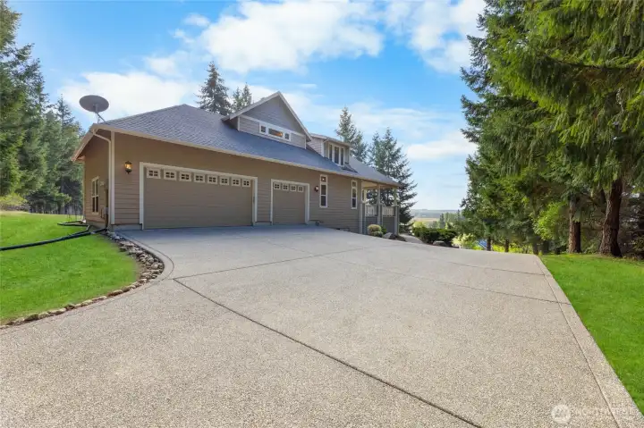 Large oversized driveway with three car garage