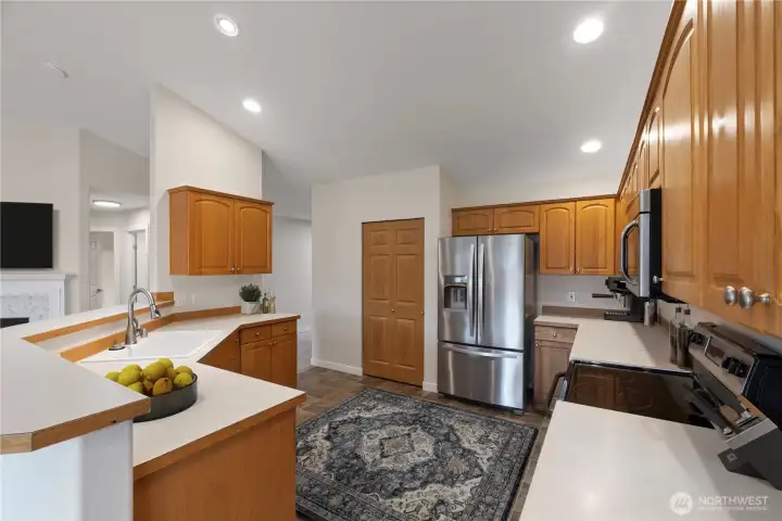 Spacious kitchen with abundant cabinetry, stainless steel appliances, and generous counter space—ideal for cooking, entertaining, and everyday convenience.