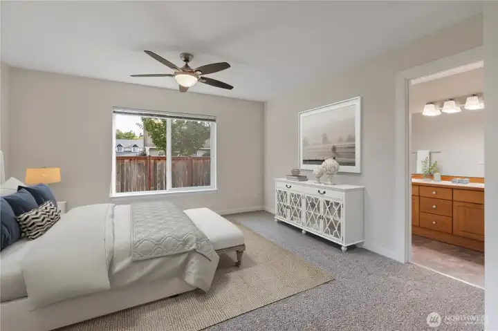 Spacious primary suite with soft natural light, new carpet, and neutral tones. Enjoy a peaceful retreat with a private ensuite bathroom just steps away.
