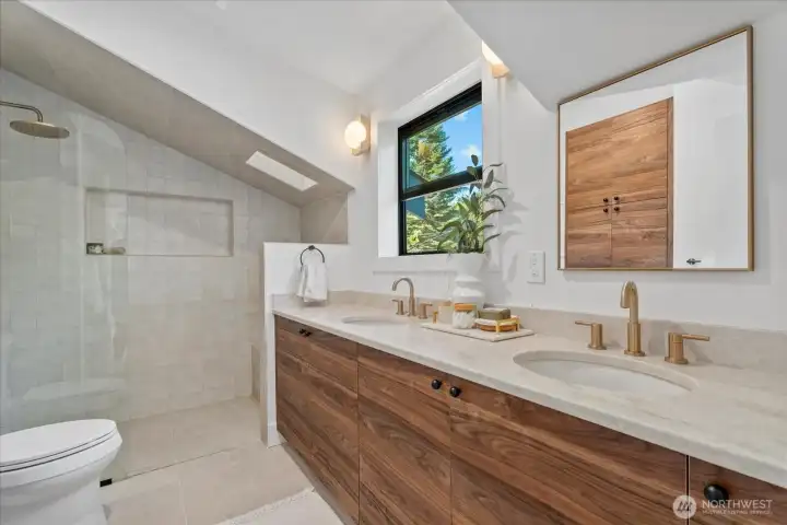 Primary bathroom.  Heated floors, a custom double-vanity, and a curbless shower with skylight and tiled ceiling make this room a peaceful sanctuary.