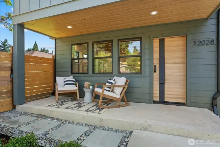 Enjoy relaxing on the beautiful, covered front porch with accented wood soffits and custom front-door.