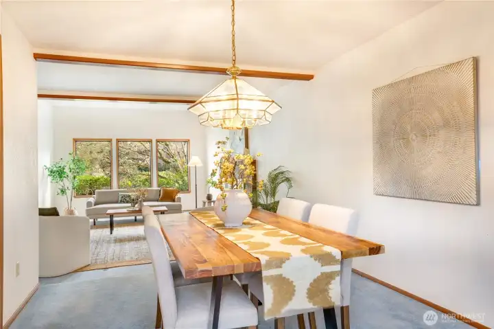 This sunny dining room has large sliders to the outside deck and yards bringing in light and greenery.  With flow to the kitchen, it makes entertaining seamless.