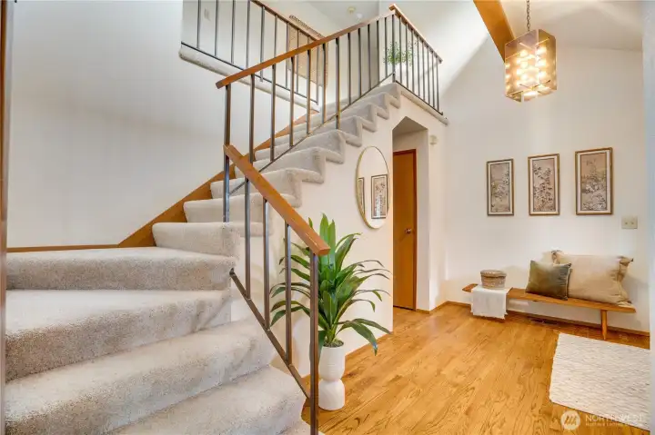 Upstairs features a gorgeous display of windows and stylish catwalk from the primary suite to the separate bedrooms and bath.