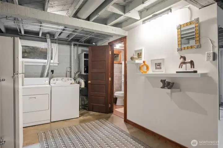 Large utility area with a half bath and room for possible expansion to add a full bath.