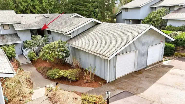 Each condo has their own garage, plus driveway parking for about two cars. Roofs are composite, siding is wood, and the newer garage doors are vinyl.