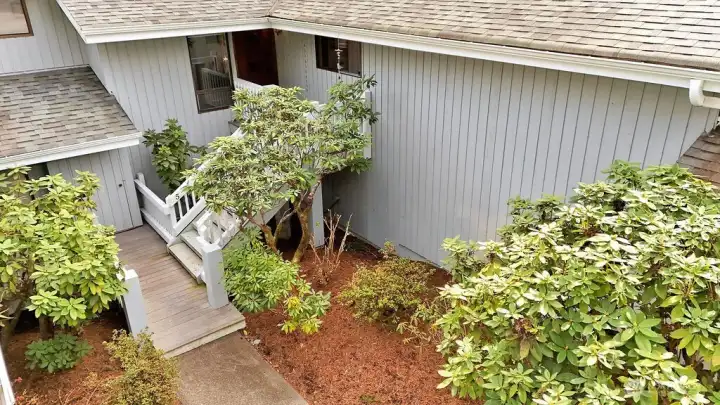 Nine steps up to your front door gives you elevated views and helps keep you moving! The HOA maintains the landscape, exterior of the building, roofs, pathways, and stairwells.