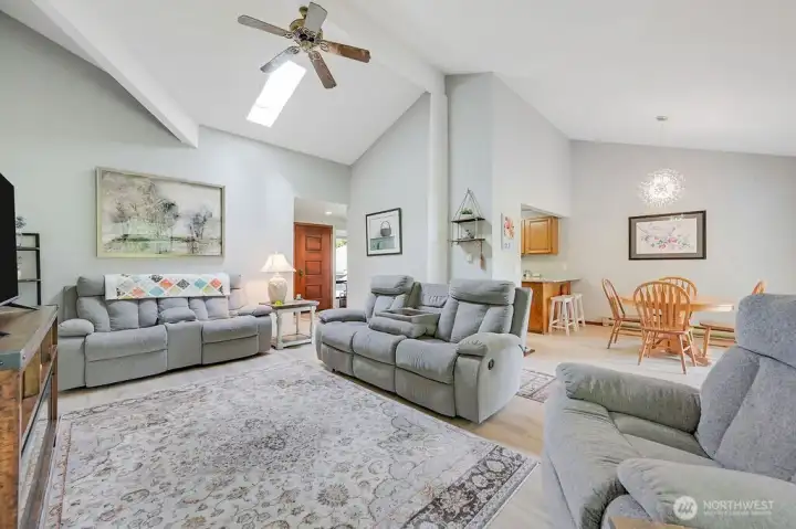 Another view of the living room with the front door in the background, and the dining area on the right.